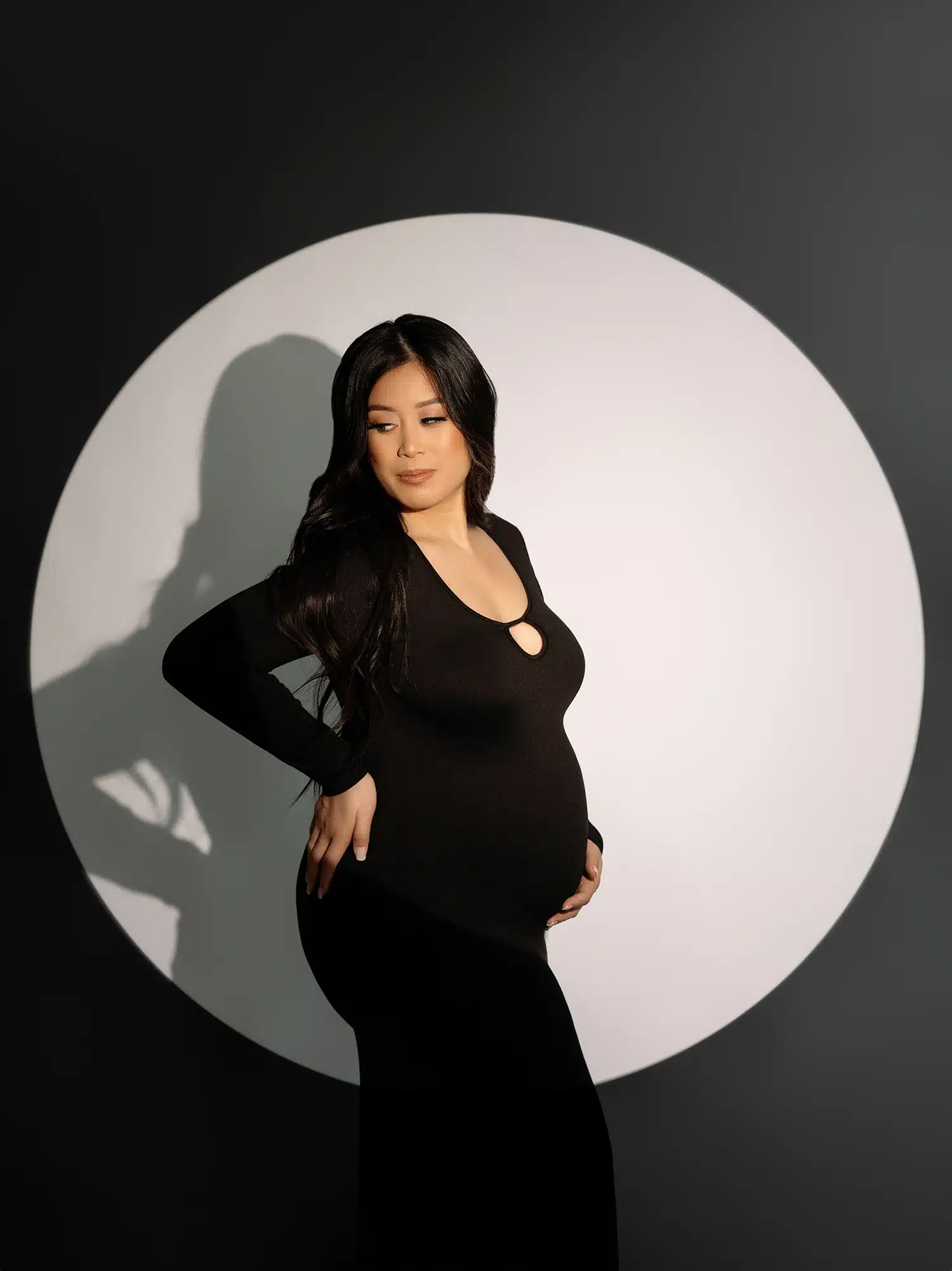 pregnant woman wearing black form-fitted tight black dress