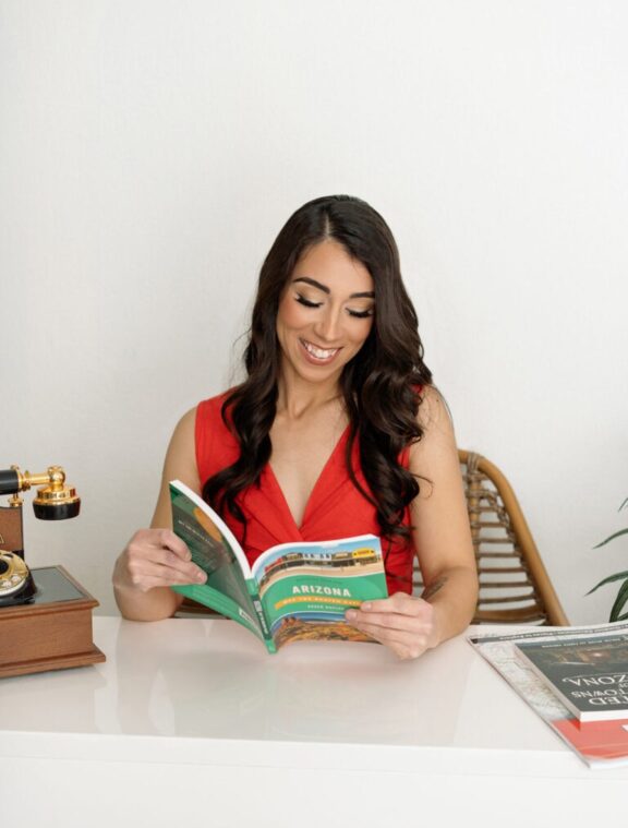 a lifestyle branding photo of a woman holding books