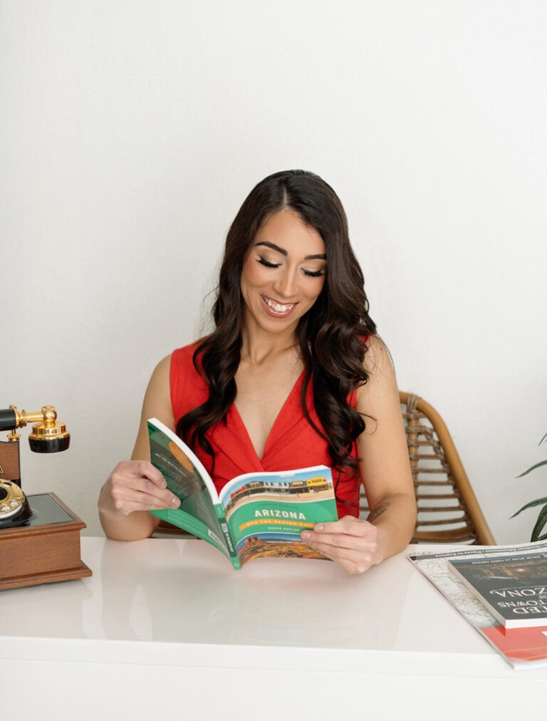 a lifestyle branding photo of a woman holding books