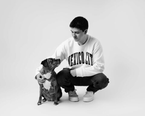 senior in their graduation photos with their dog